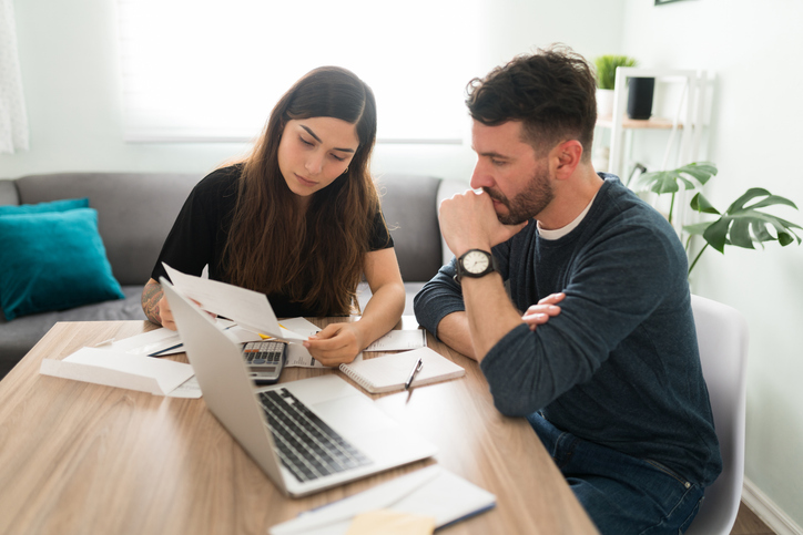 A couple estimating how much the could deduct from their paycheck in overtime.