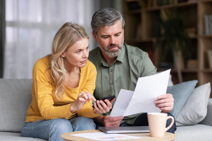 A couple reviewing taxes taken from their paychecks.